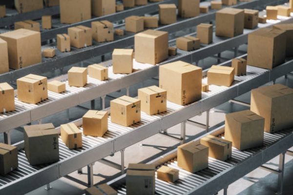 Cardboard boxes on conveyor belt in a distribution warehouse.